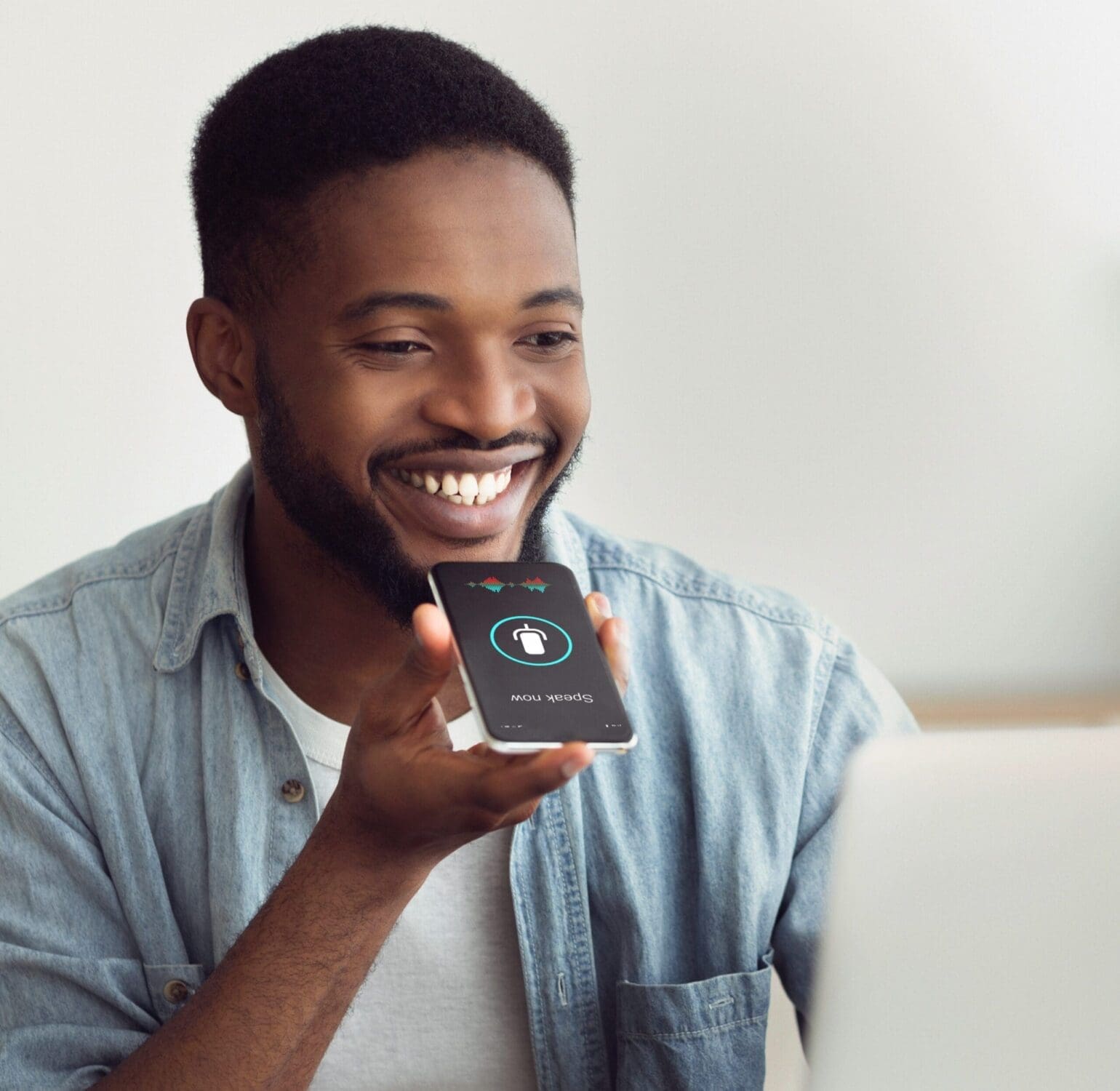 Black Guy Using Smart Phone Voice Assistant Sitting At Home